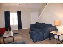 Comfortable living room featuring a plush blue sofa and an inviting atmosphere at 4190 Wingfoot Ct, Decatur, GA 30035