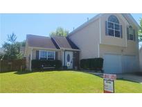 Charming two-story home with a well-manicured lawn and a two-car garage at 116 Ventura Trl, Stockbridge, GA 30281