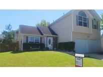 Charming two-story home with a well-maintained lawn and a two-car garage, perfect for a growing Gathering at 116 Ventura Trl, Stockbridge, GA 30281