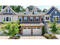 Charming brick townhome featuring a two-car garage and well-maintained landscaping at 315 Duval Dr, Alpharetta, GA 30009
