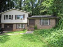 Two-story home with brick and siding, attached garage, and front yard at 5114 Fawn Se Trl, Mableton, GA 30126