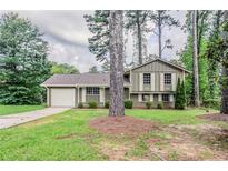 Charming home with a well-maintained front yard and attached one car garage at 2110 Redbud Sw Ct, Marietta, GA 30008