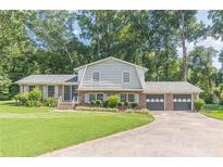 Charming home featuring a well-manicured lawn and a two-car garage at 3109 Albatross Ln, Decatur, GA 30034
