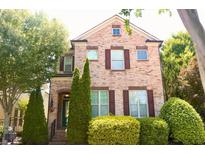 Charming two-story brick home with manicured landscaping and classic architectural details at 7825 Crownpoint Dr, Alpharetta, GA 30005