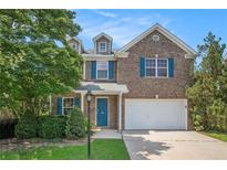 Charming two-story brick home with well-maintained landscaping and blue shutters at 926 Hawthorn Ln, Grayson, GA 30017