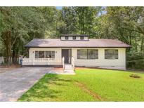 Charming, one-story home featuring a well-manicured lawn and a welcoming front porch at 558 Newlin Ct, Lawrenceville, GA 30046