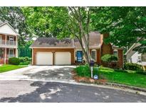 Charming brick home with a two-car garage and well-maintained front yard at 3747 Sturbridge Ct, Tucker, GA 30084