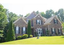 Charming brick two-story home with manicured lawn, mature trees, and beautiful curb appeal in established neighborhood at 4241 Hampton Mill Pkwy, Douglasville, GA 30135