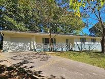 Charming single-story home featuring a spacious garage and a welcoming front porch at 1596 Allgood Rd, Stone Mountain, GA 30083
