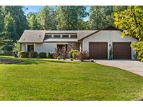 Charming single-story home with well-manicured lawn and two-car garage offers great curb appeal at 195 Pine Trail Rd, Fayetteville, GA 30214