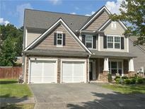 Charming two-story home with a stone-accented facade and a spacious two-car garage at 2481 Southhaven Ln, Buford, GA 30519