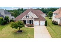 Charming one-story home featuring a manicured lawn, two-car garage, and welcoming front porch at 5345 Glenhaven Dr, Cumming, GA 30041
