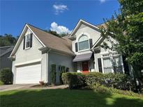 Charming home with a manicured lawn, stucco exterior, and a two car garage at 1469 Crescent Walk, Decatur, GA 30033