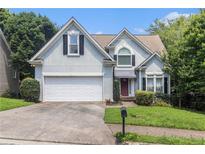 Charming two-story home with a well-maintained lawn, a two-car garage, and mature trees at 1469 Crescent Walk, Decatur, GA 30033