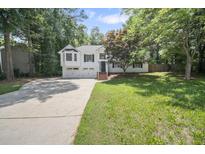 Charming two-story home with a well-manicured lawn and a two-car garage at 990 Trestle Dr, Austell, GA 30106