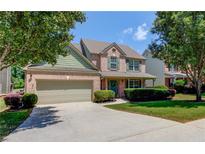 Charming two-story home with a brick facade, manicured lawn, and attached two-car garage at 3370 Battlement Cir, Loganville, GA 30052
