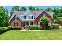 Charming brick home with well-manicured lawn and mature landscaping at 4167 Alayna Lee Cir, Mcdonough, GA 30252