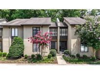 Charming townhome exterior featuring pink crape myrtle trees and lush landscaping at 12 Ivy Ne Rdg, Atlanta, GA 30342