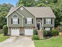Charming two-story home with a stone-accented facade, a well-manicured lawn, and a two-car garage at 3372 English Oaks Nw Dr, Kennesaw, GA 30144