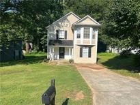 Charming two-story home featuring a well-maintained lawn and inviting front entrance at 5040 Brittany Dr, Stone Mountain, GA 30083