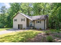 Charming home with a well-maintained lawn and beautiful landscaping at 880 Winfield Sw Ct, Marietta, GA 30060