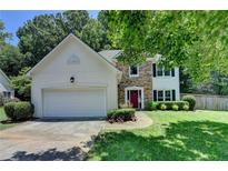 Charming two-story home with stone accents, a two-car garage, and a well-maintained front yard at 2625 Harbor Point Ct, Cumming, GA 30041