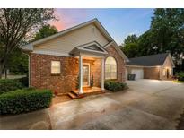 Inviting brick home featuring a charming front porch and attached two-car garage at 3309 Raes Creek Rd # 13, Marietta, GA 30008