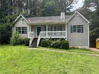 A charming single-Gathering home featuring a quaint front porch and neatly landscaped front yard at 1 Thorntree Pass, Powder Springs, GA 30127