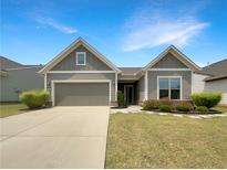 Charming one-story home featuring a two-car garage and beautifully landscaped front yard at 2838 Menton Rd, Powder Springs, GA 30127