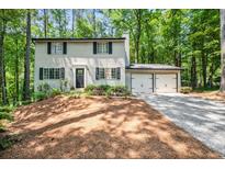 Traditional two-story home featuring a two-car garage and a well-manicured front yard at 2136 N Landing Way, Marietta, GA 30066