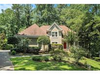 Charming single Gathering home featuring mature trees and lush landscaping at 2695 Moon Cabin Dr, Powder Springs, GA 30127