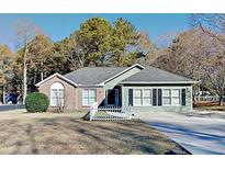 Charming home with a brick and siding exterior, complemented by a well-maintained lawn at 2082 Blackberry Ln, Auburn, GA 30011