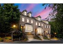 Beautiful townhome exterior featuring brick facade, dormer windows, and well-maintained landscaping at 538 Sarabrook Pl, Sandy Springs, GA 30342