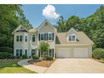 Traditional two-story home featuring a two-car garage and manicured front lawn at 3275 Cherry Oak Ln, Cumming, GA 30041