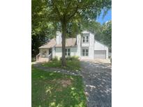 Charming two-story home featuring white siding, a well-maintained lawn, and a lush, mature tree in the front yard at 2500 Trent Dr, Marietta, GA 30066