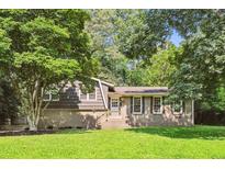 Charming brick and wood home with a well-manicured lawn and mature trees in a peaceful setting at 5510 Stoneybrook Se Ct, Mableton, GA 30126