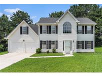 Charming two-story home with white siding, black shutters, and a well-manicured front lawn at 2601 Brandenberry Dr, Decatur, GA 30034