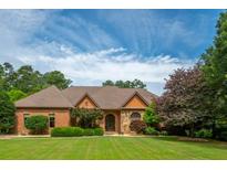 Beautiful single-story brick home with lush green lawn and mature trees at 3505 Watson Rd, Cumming, GA 30028