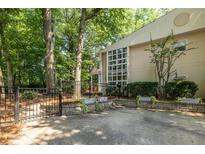Inviting home exterior featuring a wall of windows, lush greenery and a gated entrance at 1192 Cleburne Ne Ave, Atlanta, GA 30307