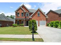 Charming two-story brick home with well-manicured lawn and two-car garage, perfect for Gathering living at 1147 Scenic Park Trl, Lawrenceville, GA 30046