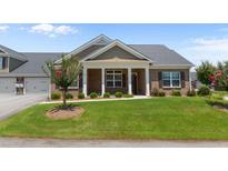 Charming home featuring brick facade, covered porch, and manicured lawn at 3209 Telhurst Way, Buford, GA 30519