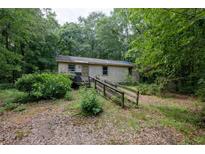 Exterior view of the property showcasing the facade and surrounding landscape at 400 Mccart Rd, Mcdonough, GA 30252