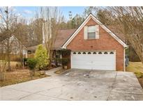 Charming brick home with a two-car garage and well-manicured front yard at 105 Hunters, Mcdonough, GA 30253