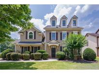 Charming two-story home with a manicured lawn and symmetrical landscaping at 115 Dunlavin Dr, Acworth, GA 30102