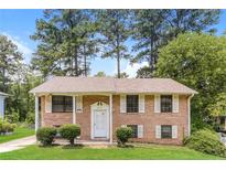 Charming brick home features a well-maintained lawn and classic architectural details at 4133 Conley Circle Cir, Conley, GA 30288