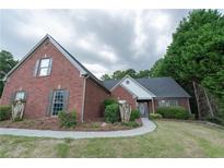 Charming single-Gathering home with brick exterior, manicured lawn and a welcoming walkway at 1200 Martins Chapel Se Ln, Lawrenceville, GA 30045