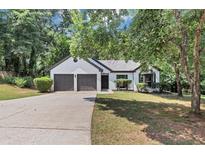 Charming one-story home with a two-car garage and well-maintained front yard at 3021 Stone Bridge Sw Trl, Conyers, GA 30094