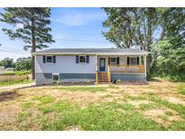 Charming single-story home with a covered front porch and freshly landscaped front yard at 6607 Forestdale Ln, Douglasville, GA 30135
