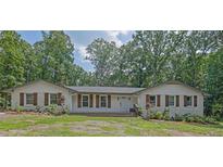 Charming single-story home with brick accents, wood shutters, and a well-manicured front yard at 2546 N Crestview Dr, Grayson, GA 30017