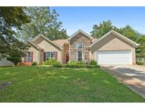 Charming home with stone accents, red shutters, manicured lawn and mature trees at 625 Chaseridge Dr, Mcdonough, GA 30253